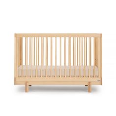 a small wooden crib with white sheets on the bottom and sides, against a white background