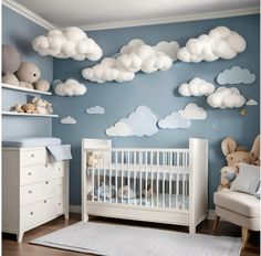 a baby's room with clouds painted on the wall and crib in the foreground