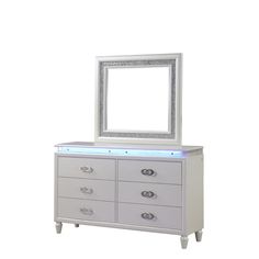 a white dresser with a mirror on top