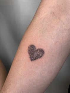 a person's arm with a fingerprint in the shape of a heart on it