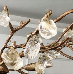 a close up of a light fixture with many glass pieces hanging from it's branches