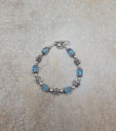 one of a kind sterling bracelet, vintage beaded bracelet, blue Swarovski jewelry Sterling Silver and Swarovski Crystal Handmade Bracelet 7 " all 4mm round beads are sterling silver. All square spacer beads, bead caps and toggle clasp are Bali sterling silver. Swarovski crystals are 8mm round aquamarine Check out my other jewelry at https://loveofjewelryshop.etsy.com *All of my Swarovski crystal bracelets, earrings, and necklaces are my own design using beads I purchased over 20 years ago. Handmade Blue Sterling Silver Charm Bracelet, Handmade Adjustable Sterling Silver Rosary Bracelet, Silver Jewelry With Birthstone Round Beads, Blue Faceted Beads Bracelet, Silver Jewelry With Round Birthstone Beads, Blue Vintage Nickel Free Bracelets, Vintage Blue Nickel-free Bracelets, Vintage Blue Nickel-free Bracelet, Handmade Blue Sterling Silver Beaded Bracelets