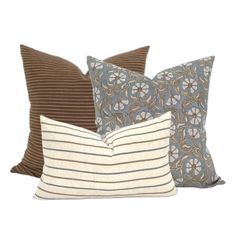 three pillows with different colors and designs on them, one in brown, the other in blue