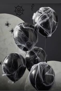 black and white balloons with spider web on them