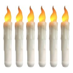 six lit candles with yellow flame on white background