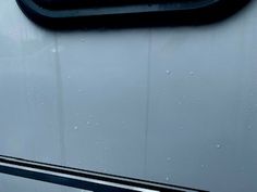 the back end of an rv with rain drops on it