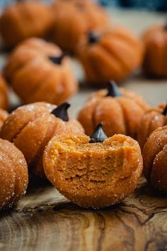 small pumpkin shaped pastries on a wooden table