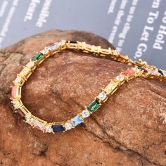 Rainbow Sapphire and cubic zircon  Stackable Eternity tennis  Bracelet Simple Line Bracelet Dainty emerlad Cut Tennis Bracelet Gradient Multicolor Gemstone Boho Gift  | emerald cut lab grown gemstone tennis bracelet gold | Art Deco vintage emerald bracelet gold best gift for her  Item Details Metal: 925 Sterling Silver Main stone creation-  Multi Sapphire  (lab created) Main Stone Color: multi Main Stone Shape: Emerald cut Stone Sizes: Rainbow Sapphire Baguette 5x3mm Faceted Stone Sizes:  CZ  Round 3mm Faceted Cutting technique- Cut Theme: Dainty, Statement & Engagement Method: handmade Personalization: Possible Occasion: Wedding bracelet, engagement bracelet, birthday bracelet, bracelet for her, proposal best bracelet Style: Minimalist Bracelet Size: We make bracelet length =  5 , 5.50, 6 Multicolor Cubic Zirconia Tennis Bracelet Gift, Cubic Zirconia Tennis Bracelet With Jubilee Design, Cubic Zirconia Jubilee Tennis Bracelet Gift, Multicolor Cubic Zirconia Tennis Bracelet For Anniversary, Crystal Tennis Bracelet With Jubilee Design, Crystal Jubilee Tennis Bracelet Gift, Cubic Zirconia Tennis Bracelet With Sparkling Stones, Emerald Bracelet Gold, Rainbow Sapphires