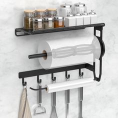 a kitchen wall shelf with pots, pans and utensils hanging on it