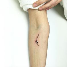 a woman's arm with a small tattoo on the left side of her leg