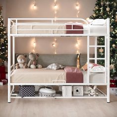 a white bunk bed sitting next to a christmas tree