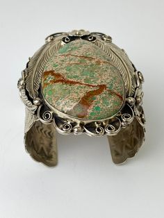 "Vintage Artisan Natural Sea Sediment Jasper Cuff Bracelet - Beautifully made by Navajo artist Percy Spencer - piece is signed - Substantial heavy rigid cuff - Navajo or coin silver, non-magnetic - Huge stone surrounded by very intricate silver work with feathers, flowers, swirls and stamp work on the arm cuff - The jasper stone is natural with lots of green, dark brown matrix and a tan colored background. Almost perfect teardrop shape. - Face of cuff measures 3.5\" x 2.5\" - Width of arm band 2 Bohemian Adjustable Untreated Bracelets, Artisan Collectible Cuff Jewelry, Unique Adjustable Inlay Cuff Bracelet, Bohemian Silver Cuff Bracelet With Patina, Silver Bohemian Cuff Bracelet With Patina, Bohemian Adjustable Cuff Bracelet With Inlay, Bohemian Engraved Cuff Bracelet Collectible, Unique Collectible Cuff Bracelet, Southwestern Style Cuff Bracelet