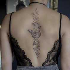 a woman with a butterfly tattoo on her back