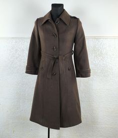 70's Vintage high-quality woolen fabric Women's coat.  Wide seventies collar, elegant shoulders and cuffs.  A fantastic tartan fabric is on the back of the collar and on the details. The coat is in autumn colors. The pockets have a beautiful cut. Long, narrow buttons as a decoration for a coat.  A narrow belt with beveled ends. Quality lining. Comfortable, elegant and in very good condition. The perfect loden for celebrations, special events and everyday wear. Type:   Coat Color:  Brown Size:  like US M. Check measures before buying. Material:  Wool, polyester Flat measurements (centimeters & Inch ) 40 cm  shoulder to shoulder  15.7  inch. 46 cm  armpit to armpit. Pit to pit. 18.1 inch. 71 cm  from neck to end of sleeve  28.0 inch.  40 cm  from armpit to end of sleeve(inside)  15.7 inch. Tartan Fabric, Spring Gifts, Brown Belt, 70s Vintage, Long Coat, Gift For Women, Tartan, Coats For Women, Everyday Wear