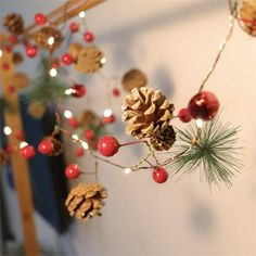 pine cones and berries are hanging from the ceiling