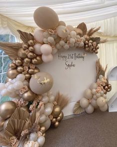 a happy 21st birthday sign surrounded by balloons and flowers in a marquee style