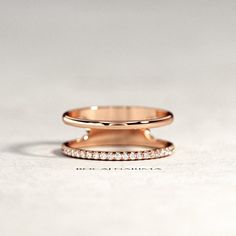 two gold wedding bands with diamonds on them