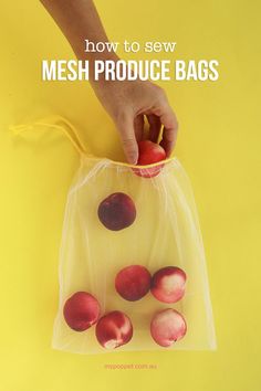 a bag filled with fresh produce sitting on top of a yellow table next to a person's hand