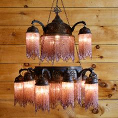 a chandelier hanging from a wooden wall