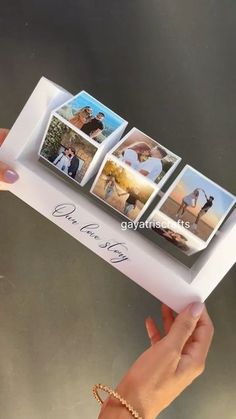 a hand holding an open photo album