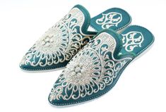 We made our Moroccan Babouche from high-quality leather and features a pointed toe and a flat heel. The leather upper is adorned with intricate embroidery and beadwork, adding a bohemian flair to these slippers. The rubber outsole provides traction and stability, making these slippers suitable for indoor and outdoor wear. Not only are these embroidered shoes Babouche stylish, they are also comfortable and practical. The pointed toe and flat heel provide a comfortable fit, and the leather upper is soft and supple, making these slippers a joy to wear. Whether you're running errands or lounging at home, our Babouche will keep your feet comfortable and stylish. Enhance your bridal attire with our luxurious Moroccan Bridal Slippers in Blue. Handcrafted by skilled artisans in Morocco, these slip Traditional Formal Slip-on Slippers, Traditional Closed Toe Mules For Festive Occasions, Traditional Embroidered Mules, Traditional Pointed Toe Mules, Traditional Embroidered Slip-on Slippers, Traditional Embroidered Closed Toe Mules, Slippers Embroidered, Moroccan Shoes, Moroccan Slippers