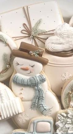 decorated cookies in the shape of snowmen and other holiday treats are arranged on top of each other