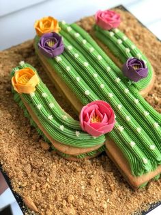 a cake shaped like a cactus with flowers on it