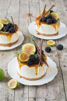 three small desserts with fruit on them