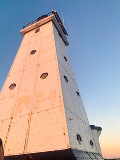 a tall white tower sitting on top of a beach