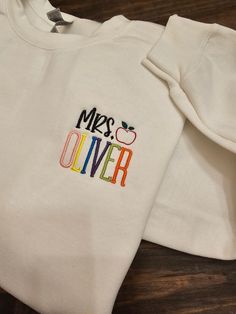 Personalized Teacher Embroidered Sweatshirt / Teacher name *The teacher's name will be in bright colors. If you would like it in one solid color, send me an email before you purchase.  Please review size chart before placing your order.  SHIPPING: Orders are shipped within 2 weeks. If you need the item sooner, message me.   CARE INSTRUCTIONS: Wash inside out and tumble dry on a low heat setting. Better results if you can wash on a cold cycle and hang/lay flat to dry. Hand Embroidered Teacher Shirt, Teacher Shirt Cricut, School T-shirt With Embroidered Text And Crew Neck, School Crew Neck Embroidered T-shirt, School T-shirt With Embroidered Crew Neck, Embroidered Crew Neck T-shirt For School, Cotton T-shirt With Embroidered Text For School, Embroidered Crew Neck T-shirt, Cotton T-shirt With Embroidered Text