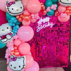 a hello kitty birthday party with balloons and streamers