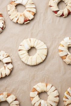 doughnuts are arranged on a baking sheet ready to be baked