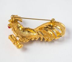 "This is enamel gold tone Rooster brooch. It consists of gold shade metal with glass rhinestones on bird body, rollover clasp, very good condition. This rooster brooch can be added to your hat, purse, favourite scarf. The brooch measurements: 1.7\" (4,5 cm) by 1.9\" (5 cm) Year: 70s-80s Made in Europe. Please feel free to email me with any questions or concerns. Take a peek at vintage jewelry: https://www.etsy.com/shop/4Rooms?ref=hdr_shop_menu&section_id=18909156" Gold Enamel Costume Jewelry Brooches, Dragonfly Jewelry Rings, Blanket Poncho, Dragonfly Jewelry, Brown Crossbody Bag, Fringed Poncho, Rhinestone Brooches, Gold Enamel, Costume Jewelry