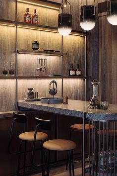 a bar with three stools and several bottles on the shelves above it, along with two lamps hanging from the ceiling