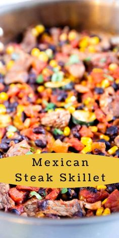 mexican steak skillet with corn, black beans, and peppers in a silver pan