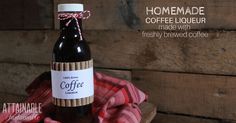 a bottle of coffee sitting on top of a red and white checkered blanket next to a wooden wall