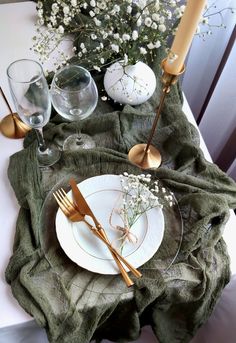 the table is set with flowers, candles and plates for two people to eat together