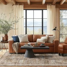 a living room filled with furniture and windows