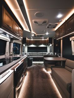 the interior of a luxury motor home with couches and tables in front of it