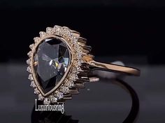 a close up of a diamond ring on a black surface with the words luminous in front of it