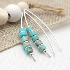 "Handmade Turquoise Threader Earrings. Perfectly suited for everyday boho vibes, these wishbone threaders feature vibrant turquoise jasper for a touch of eye-catching color that won't go unnoticed!  * Sterling Silver * Approximately 1.5\" long * Turquoise Jasper Heishi Beads * Sent in a Ribboned Gift Box with Polishing Cloth * Handmade in Montana  ----- OUR MATERIALS -----  *STERLING SILVER - Experience the elegance of Sterling Silver, a metal that combines versatility with a sophisticated look. Handmade Turquoise Earrings, Silver Threader Earrings, Open Hoop Earrings, Earrings Turquoise, Earring Cards, Heishi Beads, Threader Earrings, Everyday Earrings, Modern Earrings