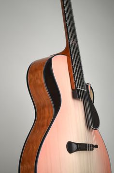 an acoustic guitar is shown against a gray background