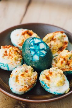 some kind of food that is in a bowl on a table with a blue and white egg