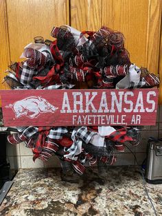 a wreath with the word arkans on it is in front of a kitchen counter