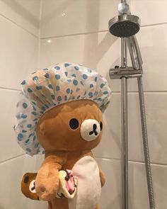 a teddy bear with a chef's hat in the shower