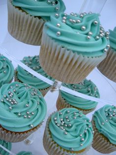 cupcakes with blue frosting and silver decorations