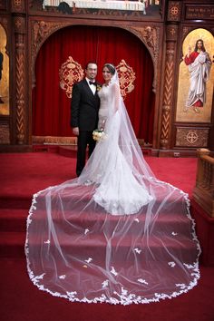 a bride and groom posing for a photo in front of the alter at their wedding