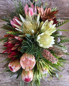 a bouquet of flowers sitting on top of a wooden table