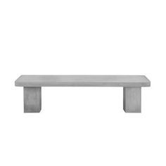 a concrete bench sitting on top of a white wall