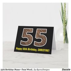 a birthday card with the number 55 on it's front, and an image of a plant in the background